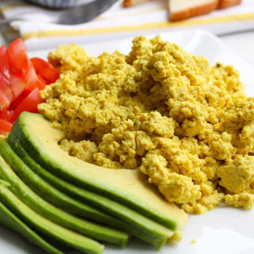 Tofu Scramble with tomatoes and avocado on a plate