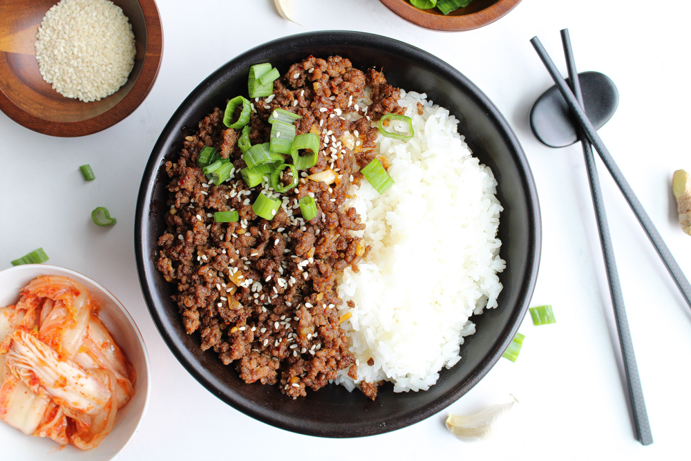 Korean Beef Rice Bowl with kimchi next to chopsticks