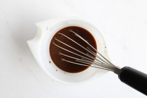 Balsamic Vinaigrette Recipe whisked in a measuring cup