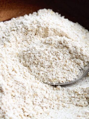 How to Make Oat Flour flour in a bowl with spoon