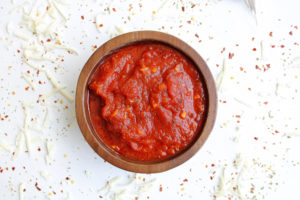 pizza sauce from tomato paste in a bowl with cheese