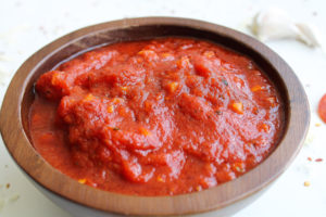 pizza sauce from tomato paste close up side view