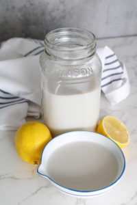 non dairy substitutes for dairy vertical image of almond milk in mason jar