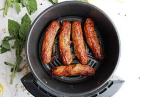 cooked air fryer Italian sausage in air fryer basket