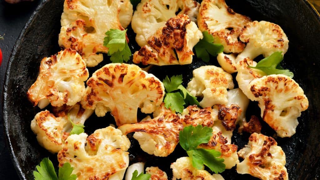 Sautéed Cauliflower in a cast iron pan with cilantro