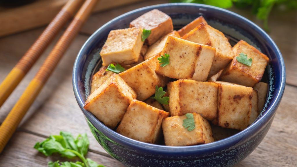 cooked cubed tofu in a blue bowl