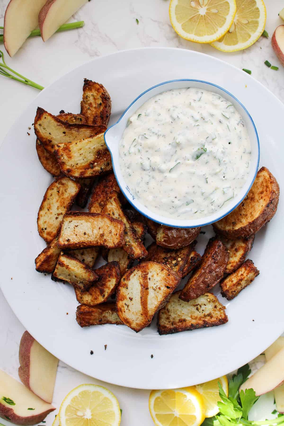 air fryer red potatoes plated with aioli