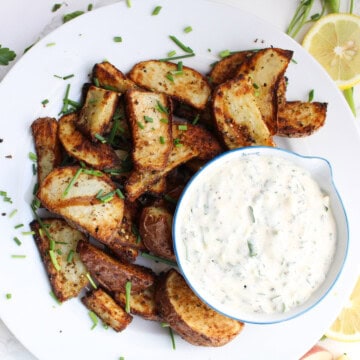 air fryer red potatoes plated with herbs and dip