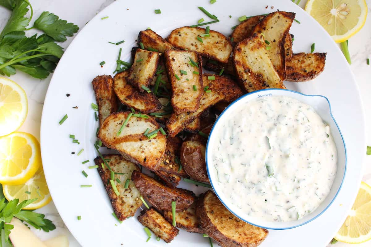 air fryer red potatoes plated with chives and cream dip